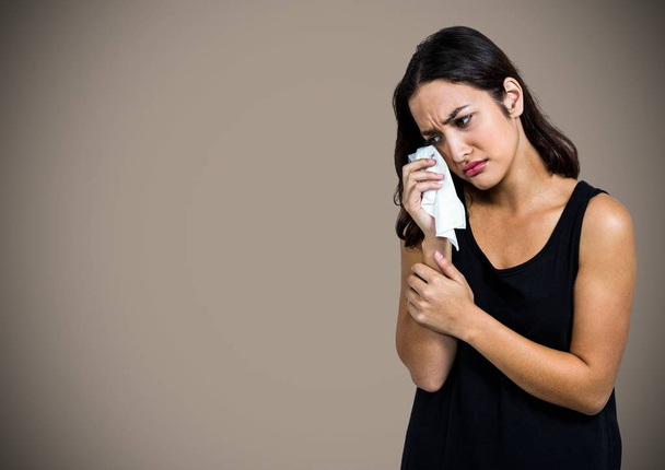 Woman crying into tissue   - Фото, зображення
