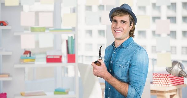 Male hipster smiling while holding smoking pipe - Foto, Bild