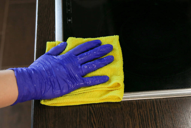 Closeup on woman's hands cleaning kitchen cabinets - Фото, изображение