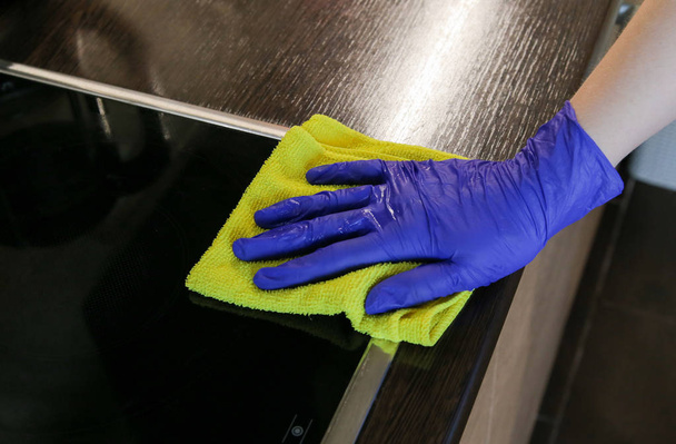 Closeup on woman's hands cleaning kitchen cabinets - Photo, Image