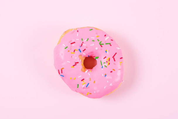 Pink round donut on pastele background. Flat lay, top view. - Photo, Image