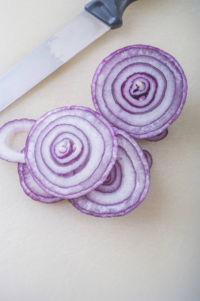 cut red onions on white table - Foto, Imagen