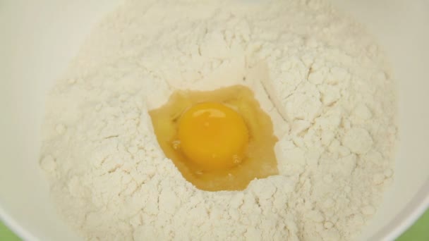 Close up of mixing eggs, melted butter and milk into a nice smooth cake mix. - Záběry, video