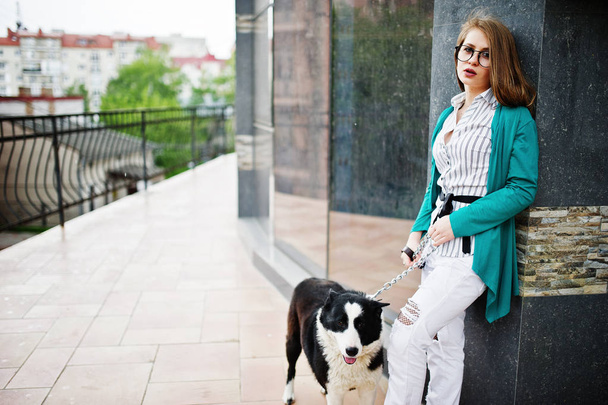 Trendy girl at glasses and ripped jeans with russo-european laik - Fotó, kép