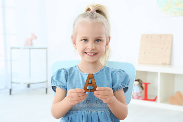 Cute little girl with letter A - 写真・画像