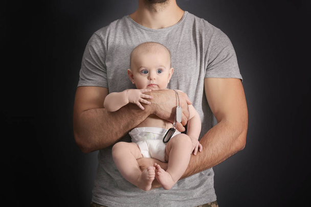 Military father holding his newborn baby - Foto, Imagen