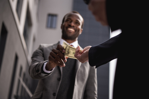 fiatal afro-amerikai üzletember vesz pénz szabadban fejrevalók - Fotó, kép