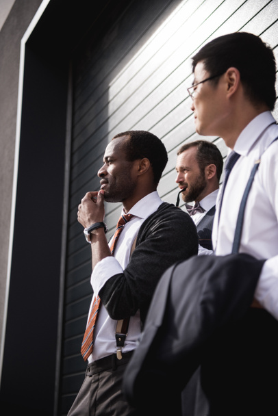 young stylish multiethnic businessmen in formalwear standing outdoors, business team meeting - Zdjęcie, obraz