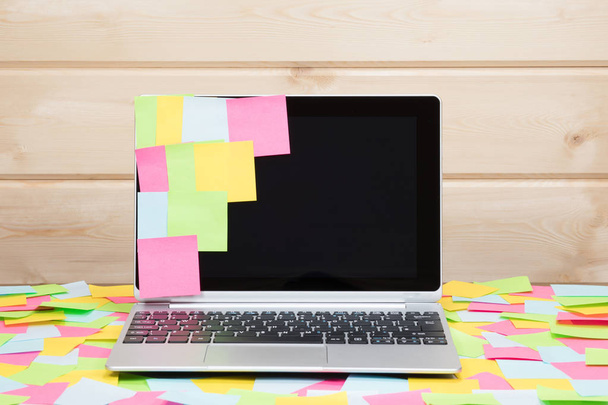 Colorful sticky notes stuck to a laptop screen - Photo, image