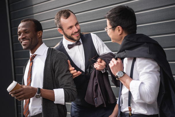 young multiethnic businessmen in formalwear talking at coffee break outdoors, business team meeting - Foto, Imagem