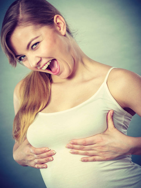 Joyful woman holding hands on her breast - Photo, image