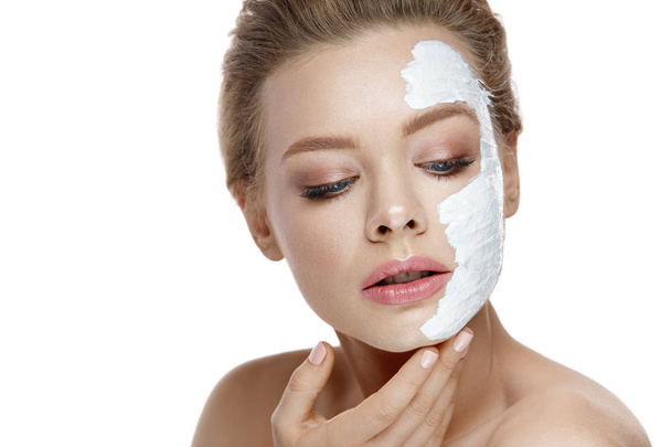 Skin Care. Young Woman Applying White Mask On Face. Cosmetics - 写真・画像