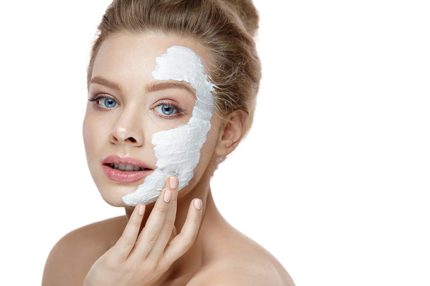 Skin Care. Young Woman Applying White Mask On Face. Cosmetics - Foto, immagini