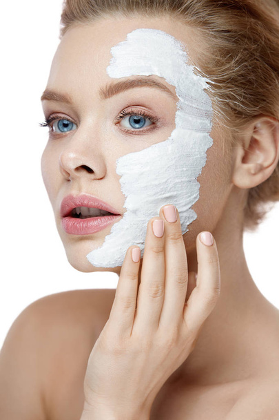 Skin Care. Young Woman Applying White Mask On Face. Cosmetics - Foto, Imagem