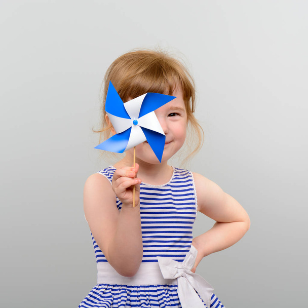 Cute girl with windmill toy - Photo, Image