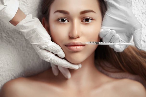 Portrait of woman getting cosmetic injection - Zdjęcie, obraz