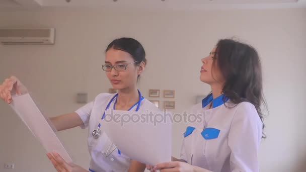 Two doctors with paper documents. - Footage, Video