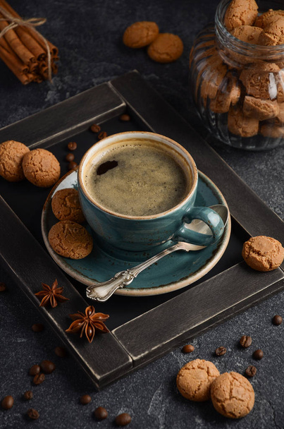 Cup of fresh coffee with Amaretti cookies on dark background - Photo, Image