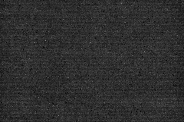 Утилизированный черный рифленый фибровый картон грубой текстуры фон
 - Фото, изображение