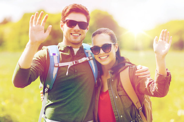 happy couple with backpacks hiking outdoors - Foto, Imagem
