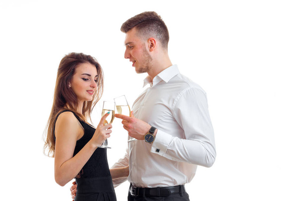beautiful young girl stands next to an attractive young man and drinking Champagne - Foto, Imagem