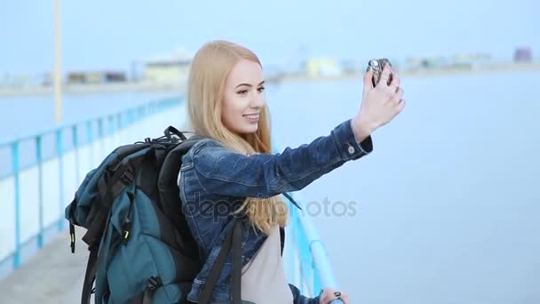 Pretty girl doing selfies standing next to the river - Footage, Video