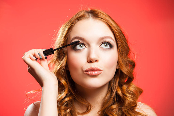 Young woman applying make up - Фото, зображення