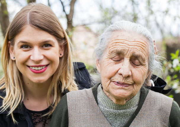 Sick old lady with her joyful carer - Photo, Image