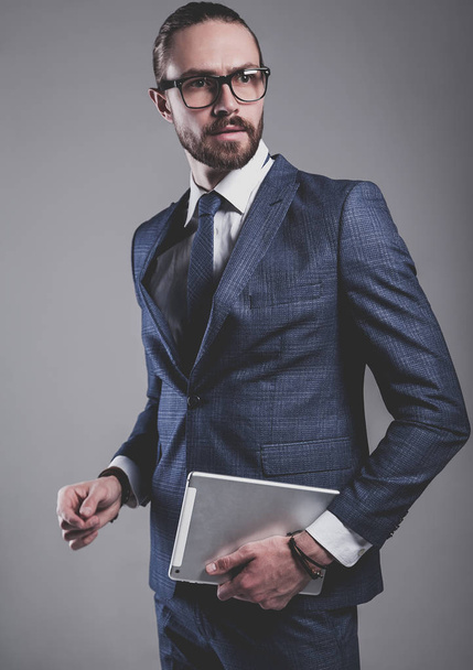 handsome fashion businessman  model dressed in elegant blue suit  - Fotó, kép