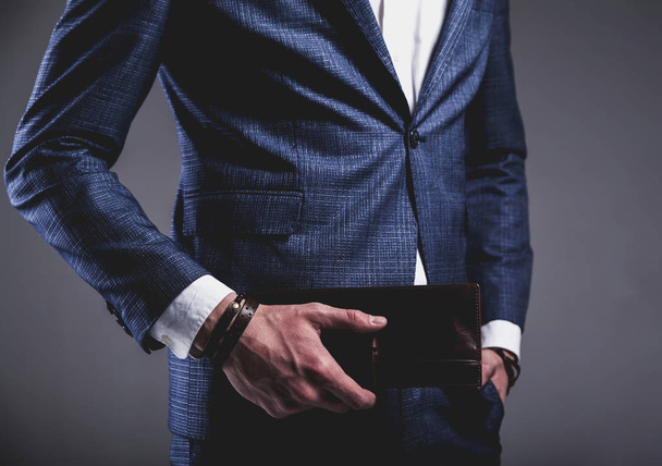 young businessman handsome model man dressed in elegant blue suit with accessories on hands  - Zdjęcie, obraz