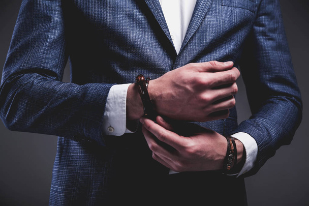 young businessman handsome model man dressed in elegant blue suit with accessories on hands  - Foto, Imagem