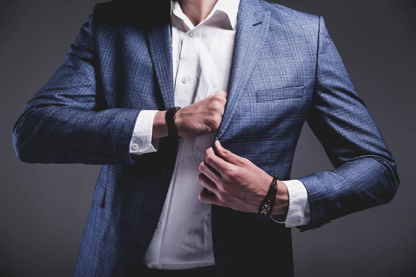 young businessman handsome model man dressed in elegant blue suit with accessories on hands  - 写真・画像