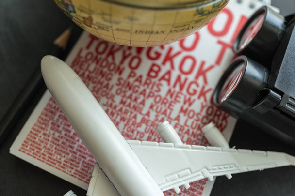 World travel concept with airplane, binoculars and paper with na - Zdjęcie, obraz