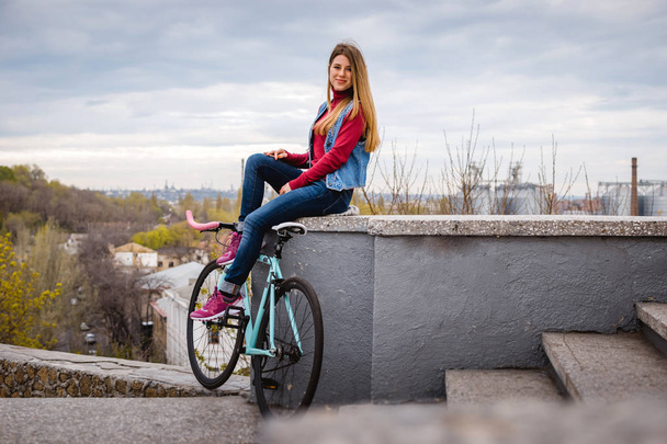 Young woman with bike - Zdjęcie, obraz