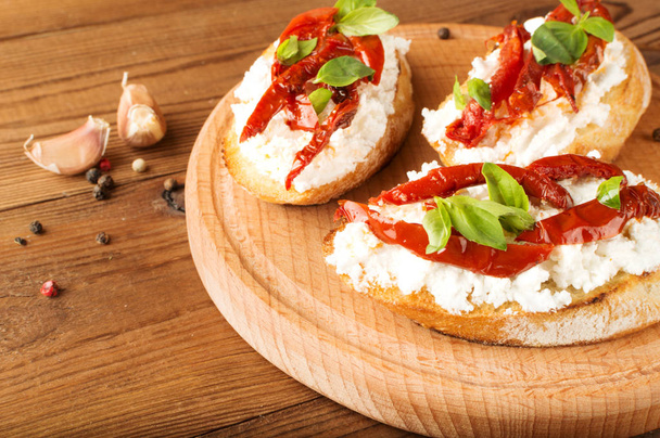 Italian sandwiches - bruschetta with cheese, tomato and basil - Photo, Image