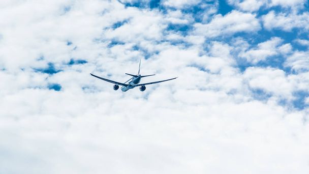 passenger plane climbs through the clouds - Фото, изображение
