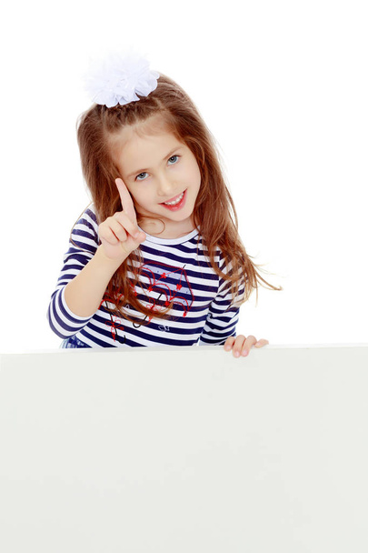 Little girl in a striped dress. - Foto, Imagem