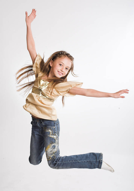 little girl jump over white background - Фото, изображение