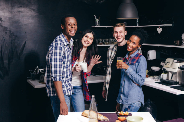 Four young man and woman have fun at home kitchen - Фото, зображення