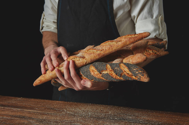 Baker keeps variety of rustic bread - Фото, изображение