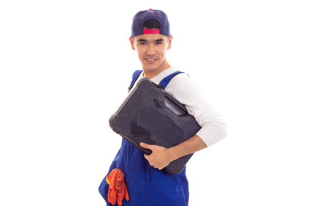 Young man in overall holding toolbox - Photo, Image