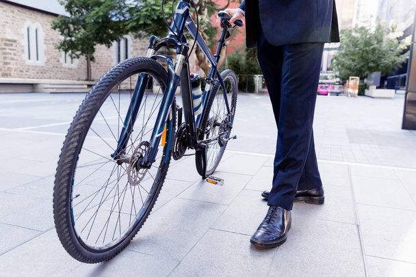 Successful businessman riding bicycle - Foto, Bild