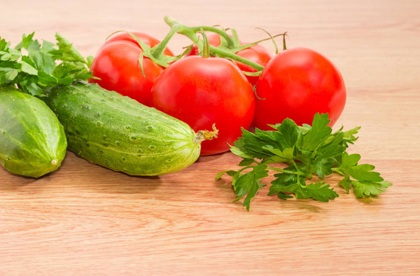 Czerwone pomidory, dwa ogórki i pietruszka zbliżenie - Zdjęcie, obraz