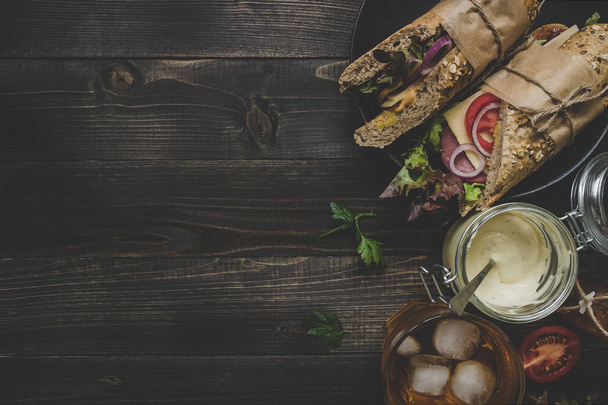 Fresh delicious submarine sandwiches on the wooden table. Top vi - Foto, immagini