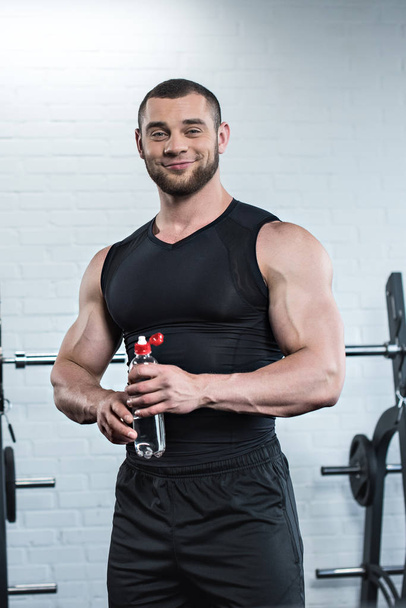 Muscular man in gym  - Фото, изображение