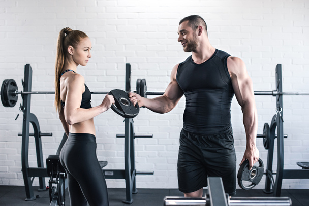 Man and woman in gym  - Фото, зображення