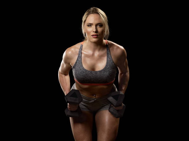 Muscular woman with dumbbells - Fotografie, Obrázek