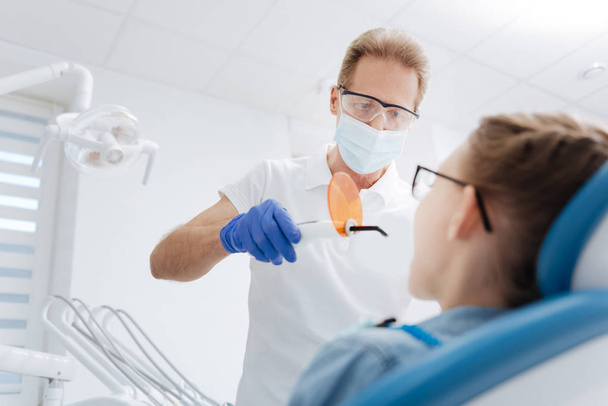 dentist employing special device - Foto, Bild