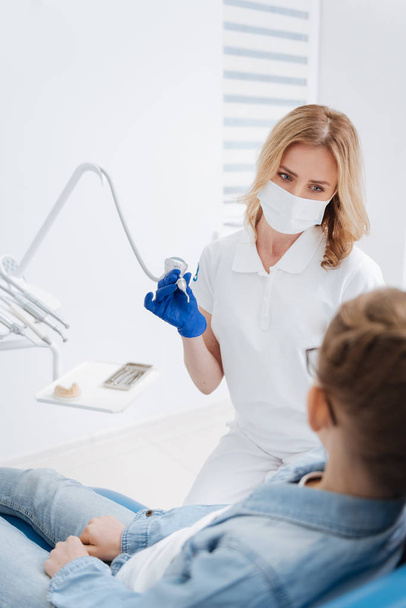 Gentle experienced dentist starting treatment process - Foto, Imagen