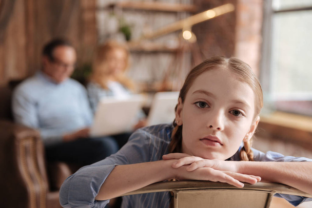 Upset kid waiting for busy parents attention at home - Photo, image